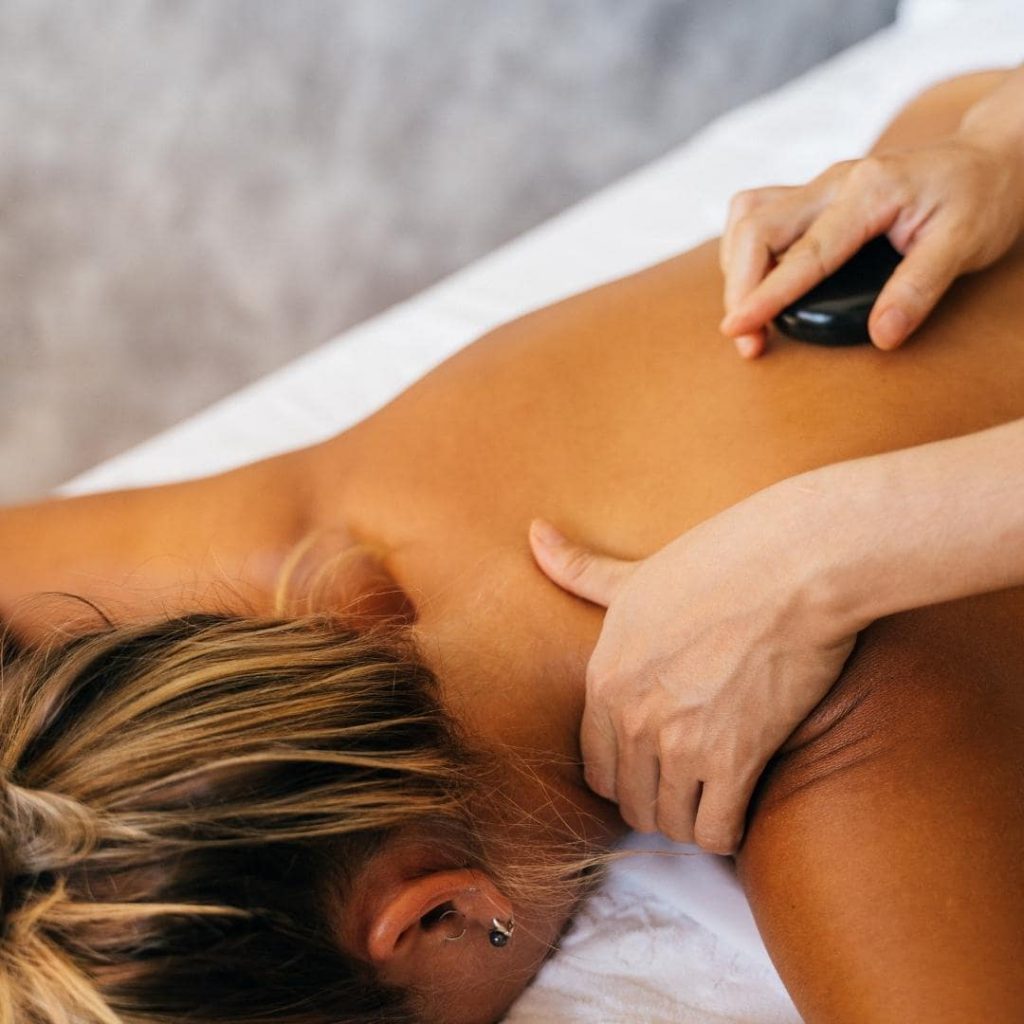 Image of woman getting a hot stone massage